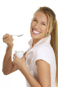 young woman eating yogurt